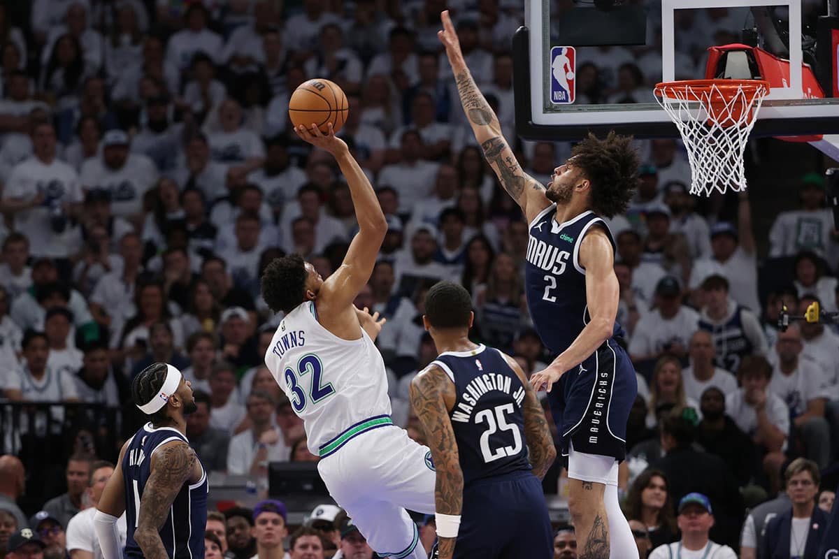 Minnesota Timberwolves center Karl-Anthony Towns (32) shoots against Dallas Mavericks center Dereck Lively II (2) in the first quarter during game one of the western conference finals for the 2024 NBA playoffs at Target Center.