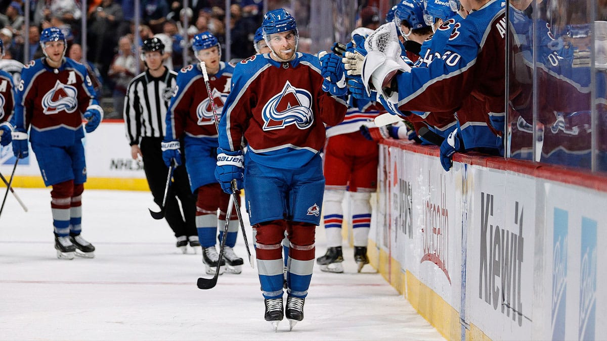 Colorado Avalanche defenseman Devon Toews (7) celebrates with the bench after his goal in the third period against the New York Rangers at Ball Arena.