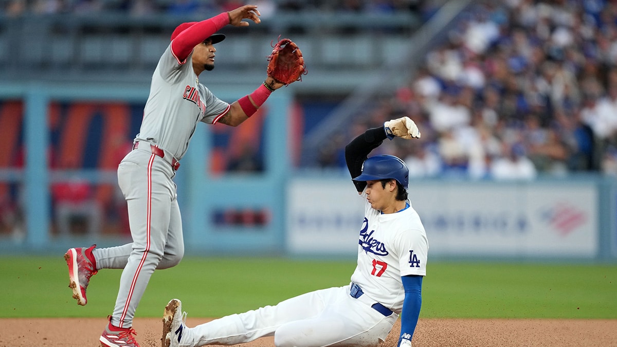 Los Angeles Dodgers designated hitter Shohei Ohtani (17) slides into second base against Cincinnati Reds second baseman Santiago Espinal (4) in the first inning at Dodger Stadium.