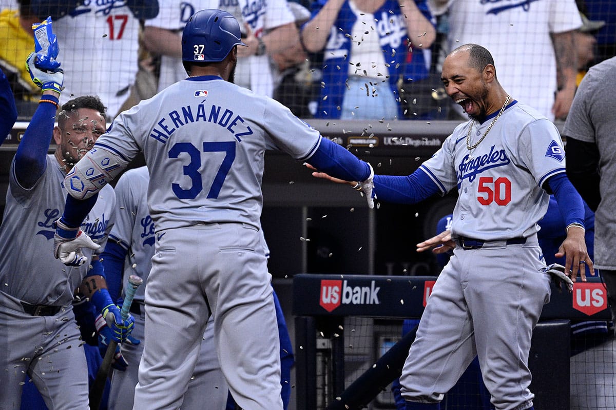 Los Angeles Dodgers left fielder Teoscar Hernandez (37) is congratulated by shortstop Mookie Betts (50) at the dugout after hitting a grand slam home run during the sixth inning against the San Diego Padres at Petco Park.
