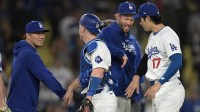 Los Angeles Dodgers starting pitcher Yoshinobu Yamamoto (18), catcher Will Smith (16), pitcher Clayton Kershaw (22) and designated hitter Shohei Ohtani (17) celebrate after the final out of the ninth inning against the Arizona Diamondbacks at Dodger Stadium.