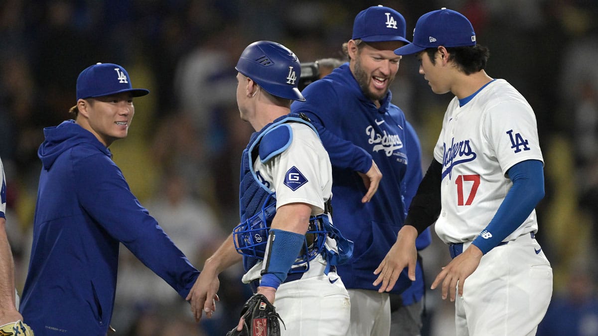 Los Angeles Dodgers starting pitcher Yoshinobu Yamamoto (18), catcher Will Smith (16), pitcher Clayton Kershaw (22) and designated hitter Shohei Ohtani (17) celebrate after the final out of the ninth inning against the Arizona Diamondbacks at Dodger Stadium.