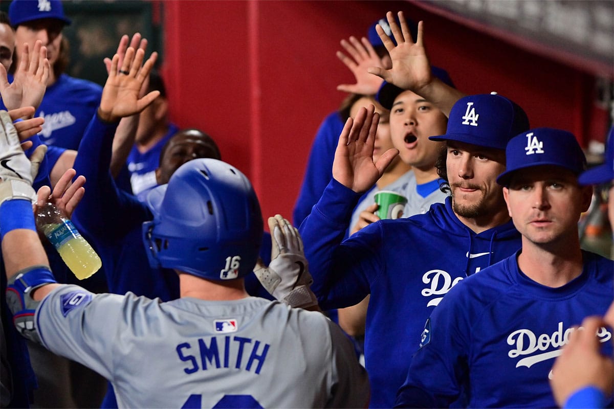 Los Angeles Dodgers catcher Will Smith (16) celebrates with teammates after hitting a solo home run in the third inning against the Arizona Diamondbacks at Chase Field.