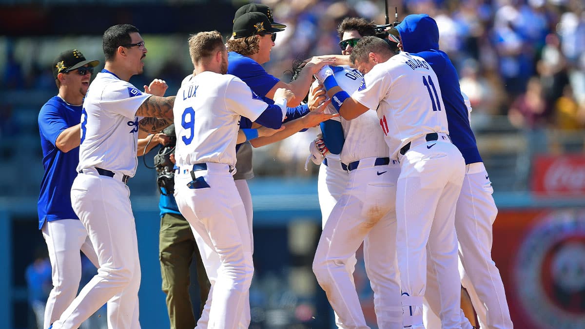 Los Angeles Dodgers celebrate after designated hitter Shohei Ohtani (17) hits a walk off RBI single against the Cincinnati Reds for the victory at Dodger Stadium