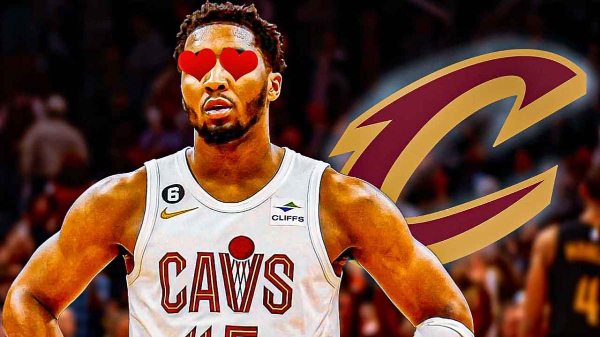 Donovan Mitchell with hearts in place of his eyes looking at a glowing Cavs logo