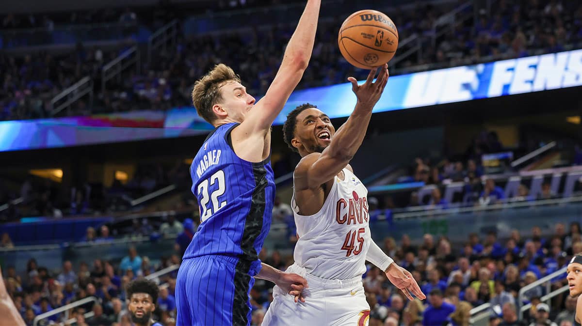 Cleveland Cavaliers guard Donovan Mitchell (45) goes to the basket in front of Orlando Magic forward Franz Wagner (22) during the second half of game six of the first round for the 2024 NBA playoffs at Kia Center. 