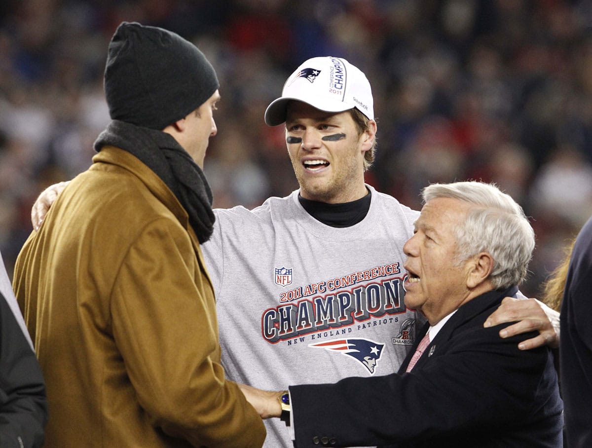 New England Patriots quarterback Tom Brady (center), owner Robert Kraft (right) and former quarterback Drew Bledsoe (left) talk after the Patriots defeated the Ravens 23-20 in the 2011 AFC Championship game at Gillette Stadium.