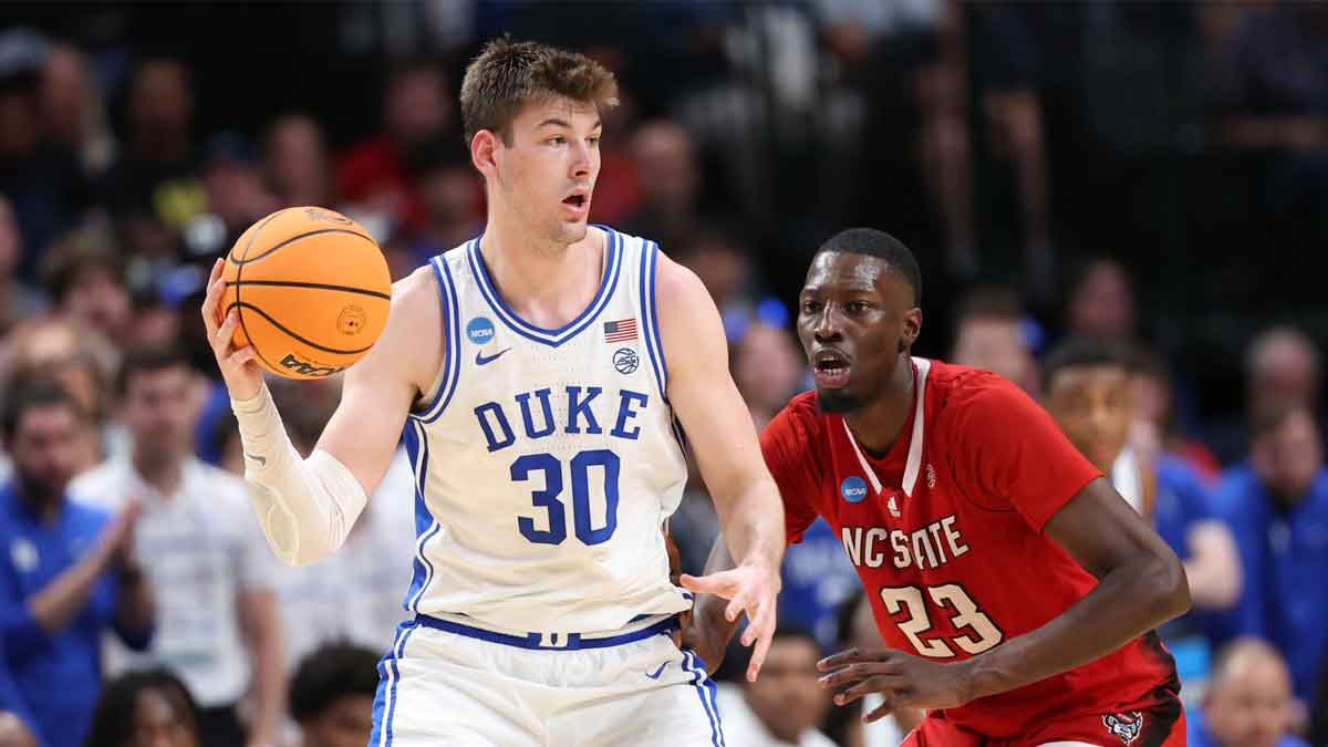 Mar 31, 2024; Dallas, TX, USA; Duke Blue Devils center Kyle Filipowski (30) controls the ball against North Carolina State Wolfpack forward Mohamed Diarra (23) in the second half in the finals of the South Regional of the 2024 NCAA Tournament at American Airline Center. Mandatory Credit: Kevin Jairaj-USA TODAY Sports