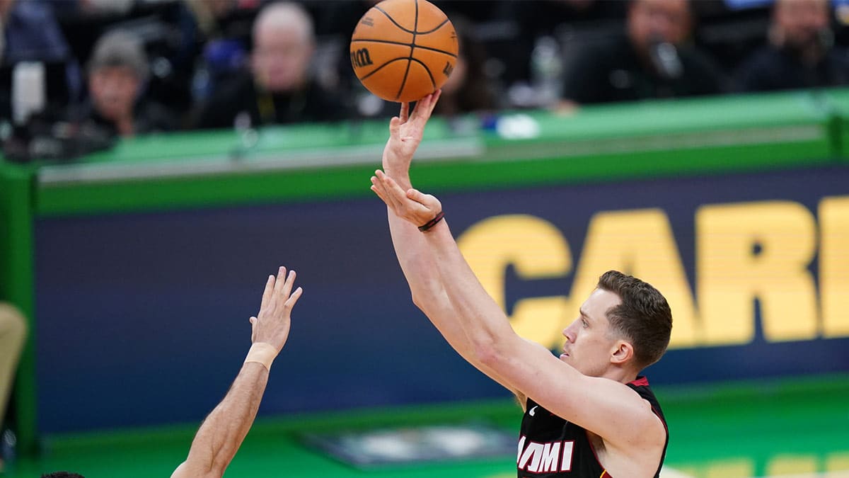Miami Heat forward Duncan Robinson (55) shoots for three points against Boston Celtics forward Jayson Tatum (0) in the second half during game two of the first round for the 2024 NBA playoffs at TD Garden.
