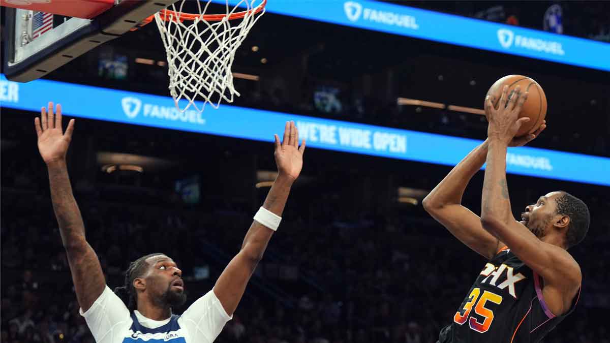 Kevin Durant shoots a fadeaway over a Wolves player. 