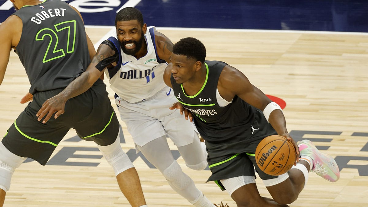 Timberwolves guard Anthony Edwards (5) dribbles against Dallas Mavericks guard Kyrie Irving (11) during the second half in game five of the western conference finals for the 2024 NBA playoffs at Target Center.