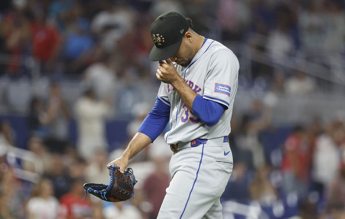 New York Mets relief pitcher Edwin Diaz (39) reacts as he leaves the mound after giving up four runs against the Miami Marlins in the ninth inning at loanDepot Park.