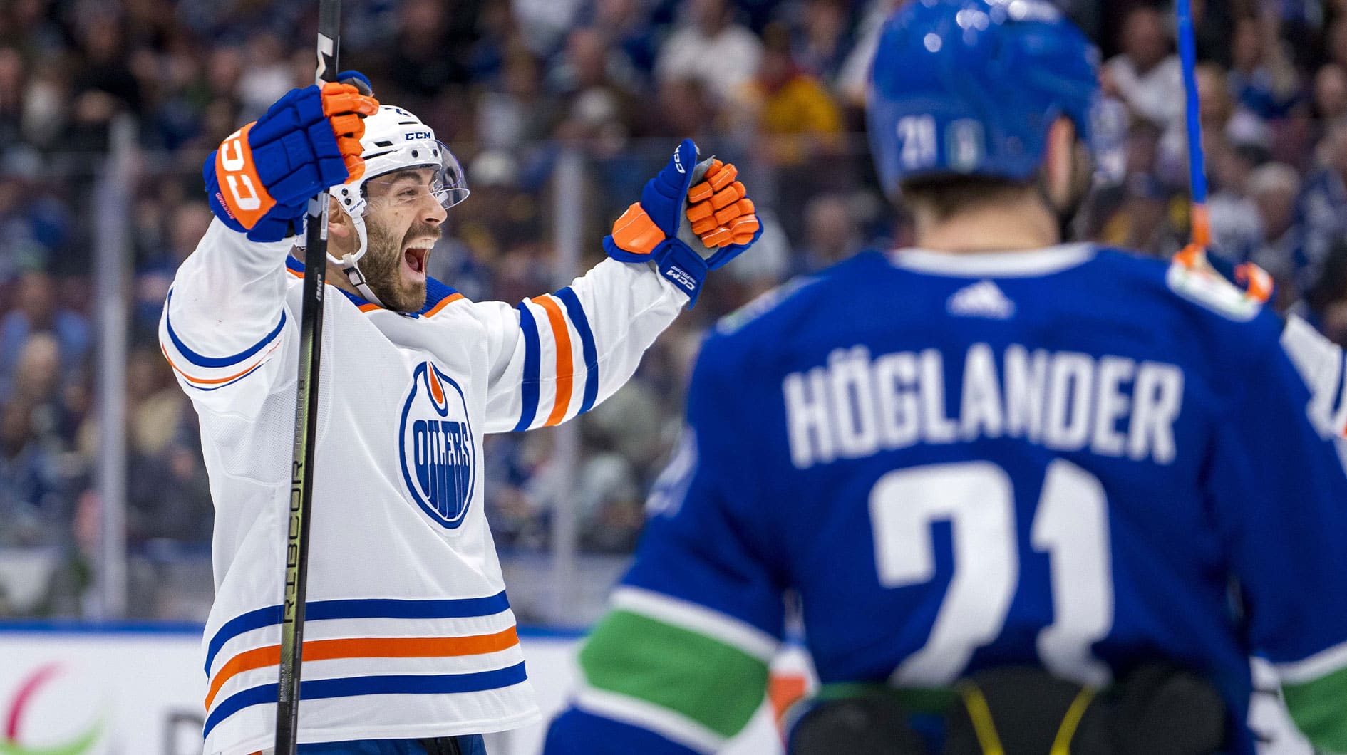 Vancouver Canucks forward Nils Hoglander (21) watches as Edmonton Oilers defenseman Evan Bouchard (2) celebrates his goal during the second period in game seven of the second round of the 2024 Stanley Cup Playoffs at Rogers Arena.