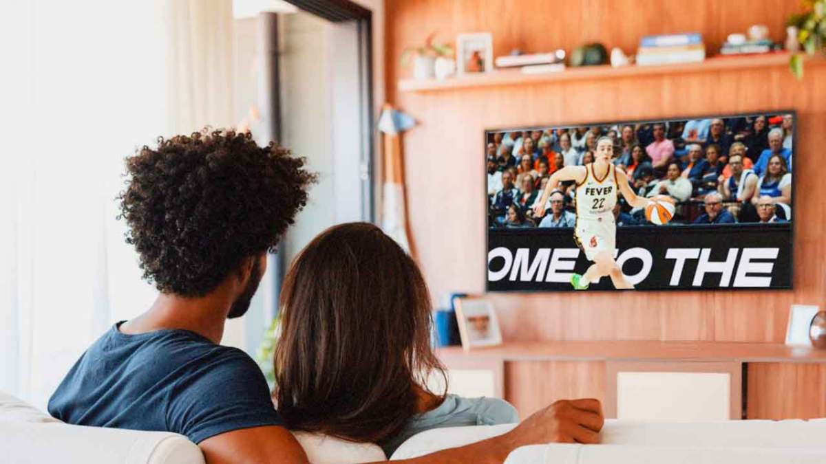 Indiana Fever player Caitlin Clark, inside of a television as if her WNBA game is being watched at home