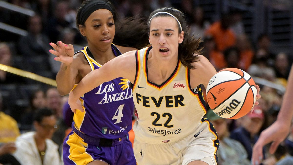 Indiana Fever guard Caitlin Clark (22) drives past Los Angeles Sparks guard Lexie Brown (4) in the first half at Crypto.com Arena.