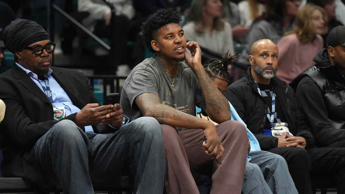 Nick Young (center) watches during the Legends of Basketball Las Vegas Invitational between the Southern California Trojans and the Gonzaga Bulldogs at MGM Grand Garden Arena.
