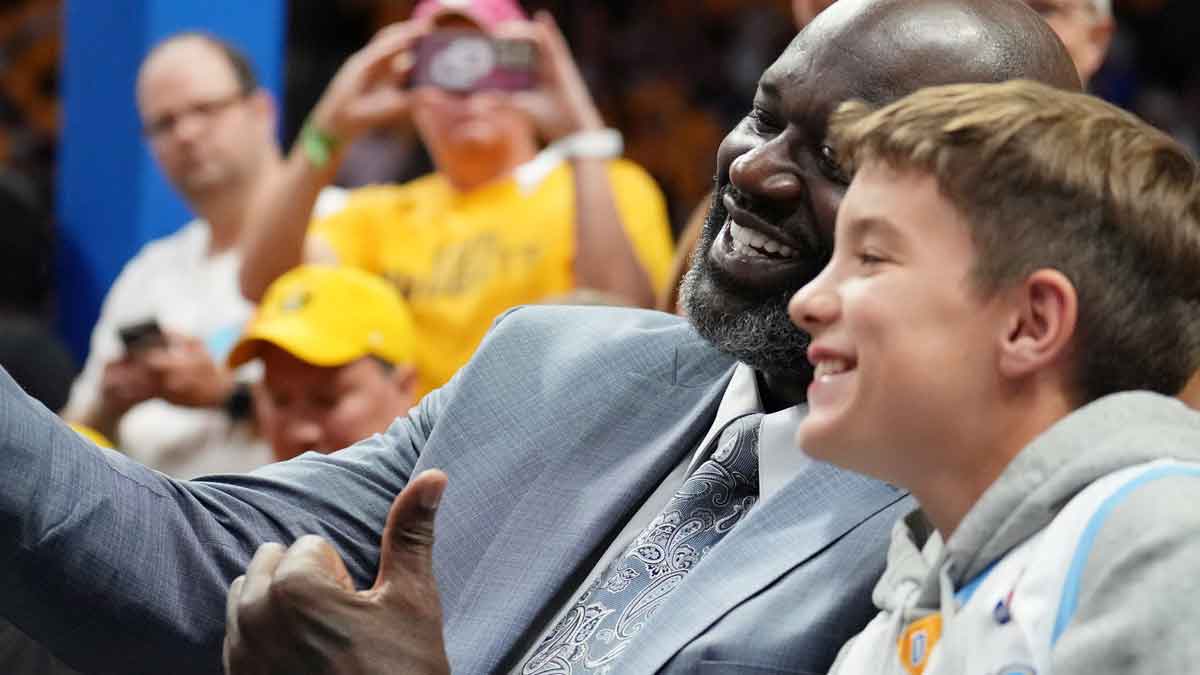 NBA former player Shaquille O'Neill takes a selfie with Marshall Manning, son of Peyton Manning (not pictured) before game one of the 2023 NBA Finals between the Miami Heat and Denver Nuggets at Ball Arena. 