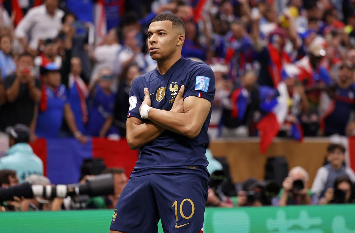 France forward Kylian Mbappe (10) celebrates after scoring a goal against Argentina on a penalty kick for his third goal of the match during extra time of the 2022 World Cup final at Lusail Stadium. 