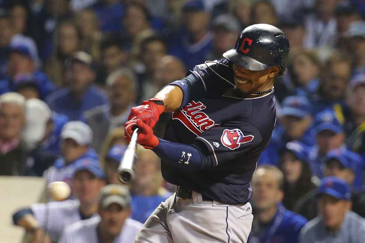 Cleveland Indians shortstop Francisco Lindor (12) hits a single during the fourth inning in game three of the 2016 World Series against the Chicago Cubs at Wrigley Field.