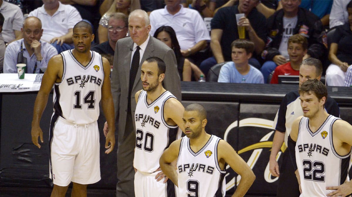 San Antonio Spurs point guard Gary Neal (14), head coach Gregg Popovich, Manu Ginobili (20), Tony Parker (9), and Tiago Splitter (22) react against the Miami Heat during the third quarter of game four of the 2013 NBA Finals at the AT&T Center. 