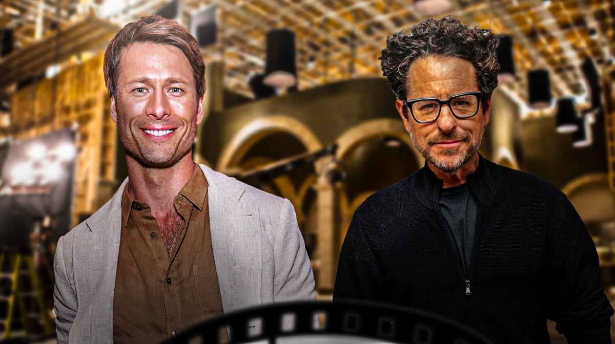 Glen Powell with Star Wars director J. J. Abrams and movie set background.