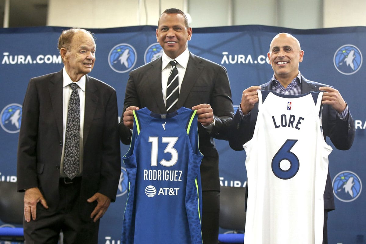 Current owner Glen Taylor and limited partners and alt-governors for the Minnesota Timberwolves Alex Rodriguez and Mark Lore hold up jerseys after answering questions at a press conference at media day.