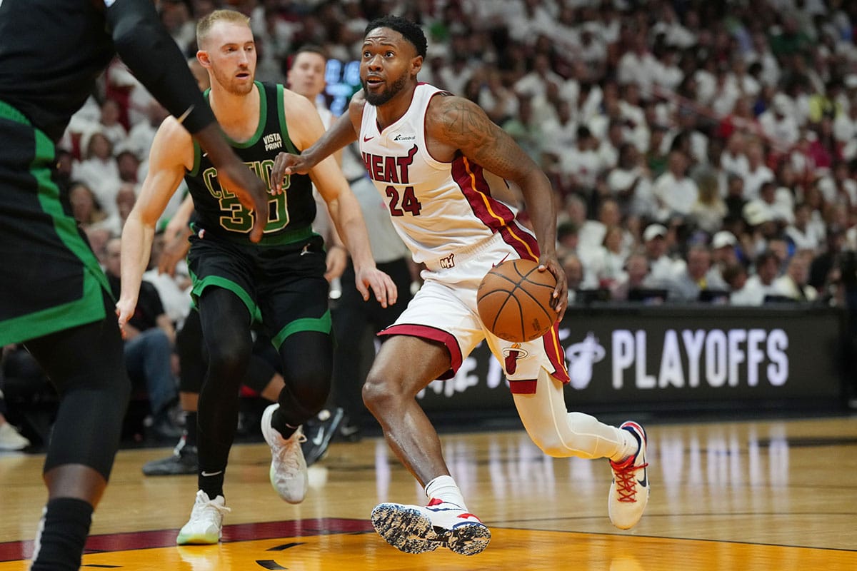 Miami Heat forward Haywood Highsmith (24) drives to the basket as Boston Celtics forward Sam Hauser (30) defends in the first half during game three of the first round for the 2024 NBA playoffs at Kaseya Center. 