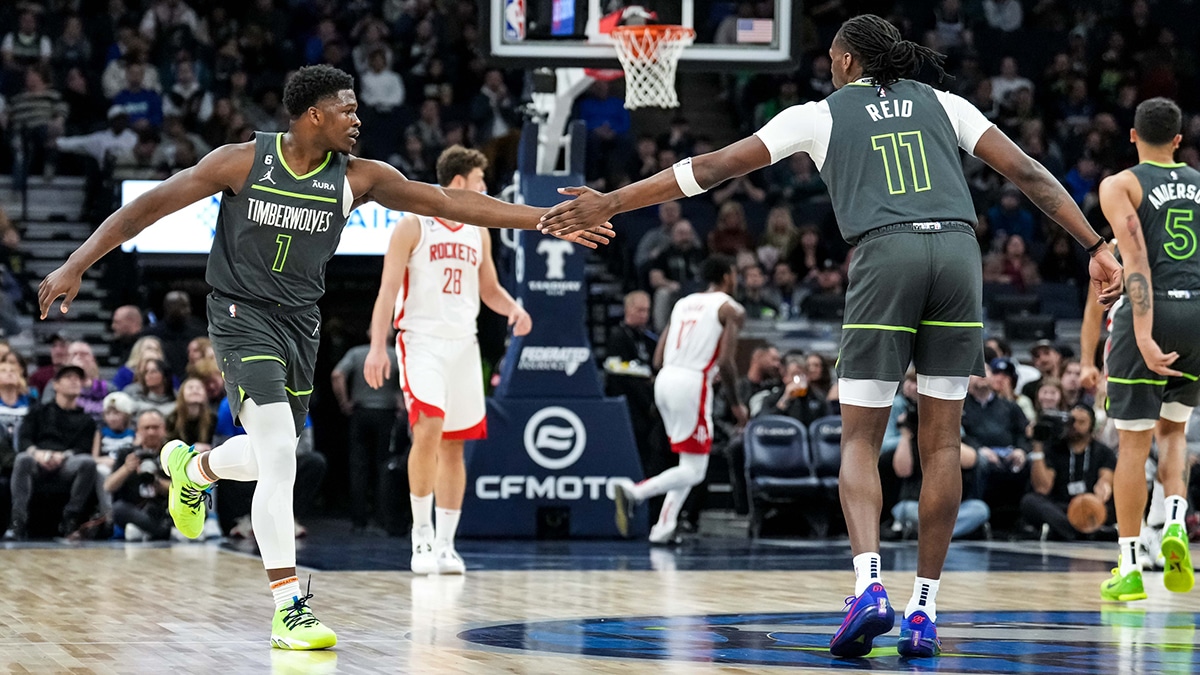 Minnesota Timberwolves guard Anthony Edwards (1) celebrates with center Naz Reid (11)