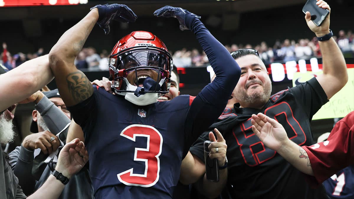 Houston Texans wide receiver Tank Dell (3) jumps in the stands and celebrates his touchdown against the Arizona Cardinals in the second quarter at NRG Stadium.