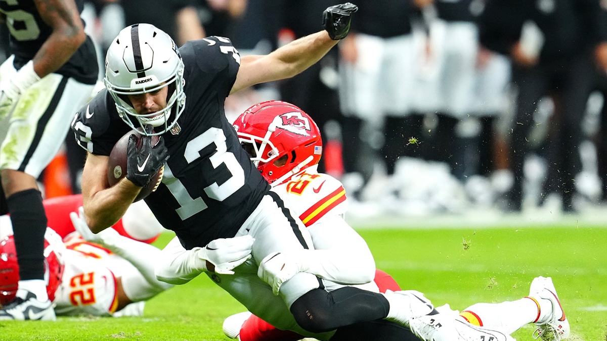 Kansas City Chiefs safety Mike Edwards (21) tackles Las Vegas Raiders wide receiver Hunter Renfrow (13) during the third quarter at Allegiant Stadium.