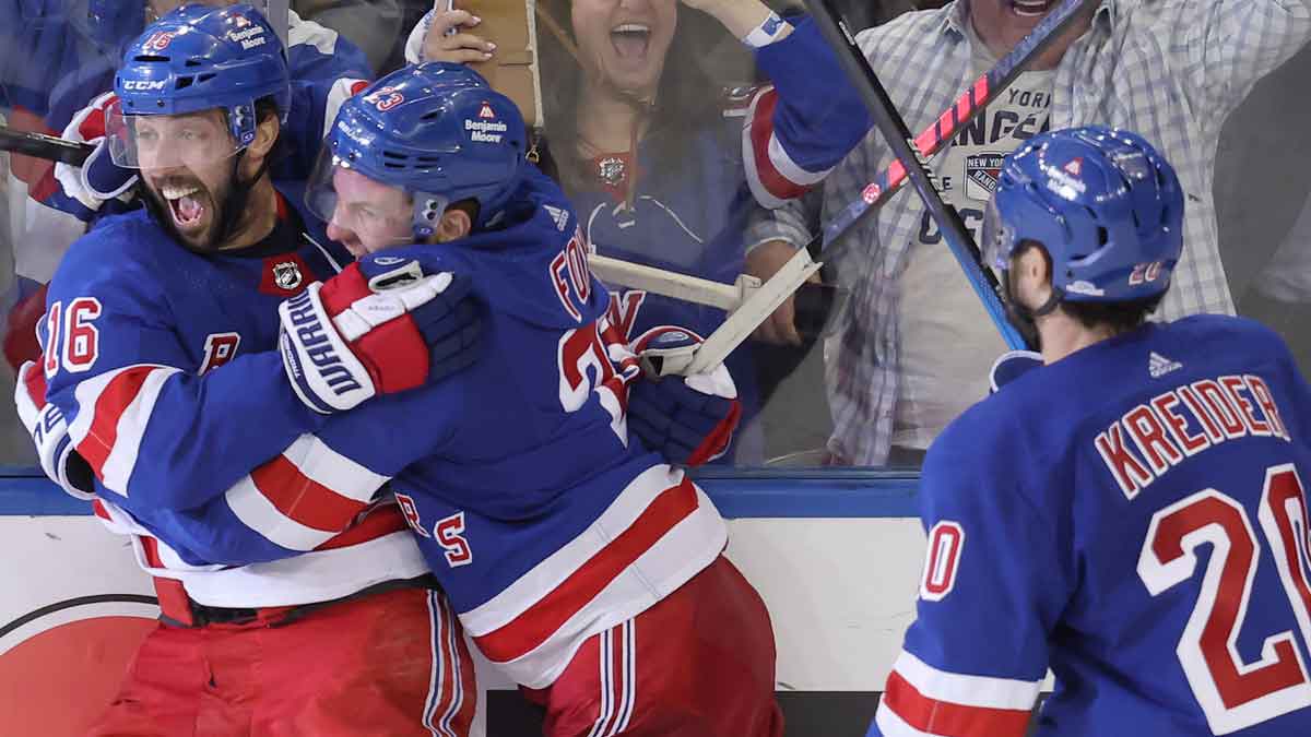 New York Rangers center Vincent Trocheck (16) celebrates his game winning goal against the Carolina Hurricanes with defenseman Adam Fox (23) and left wing Chris Kreider (20) during the second overtime of game two of the second round of the 2024 Stanley Cup Playoffs at Madison Square Garden.