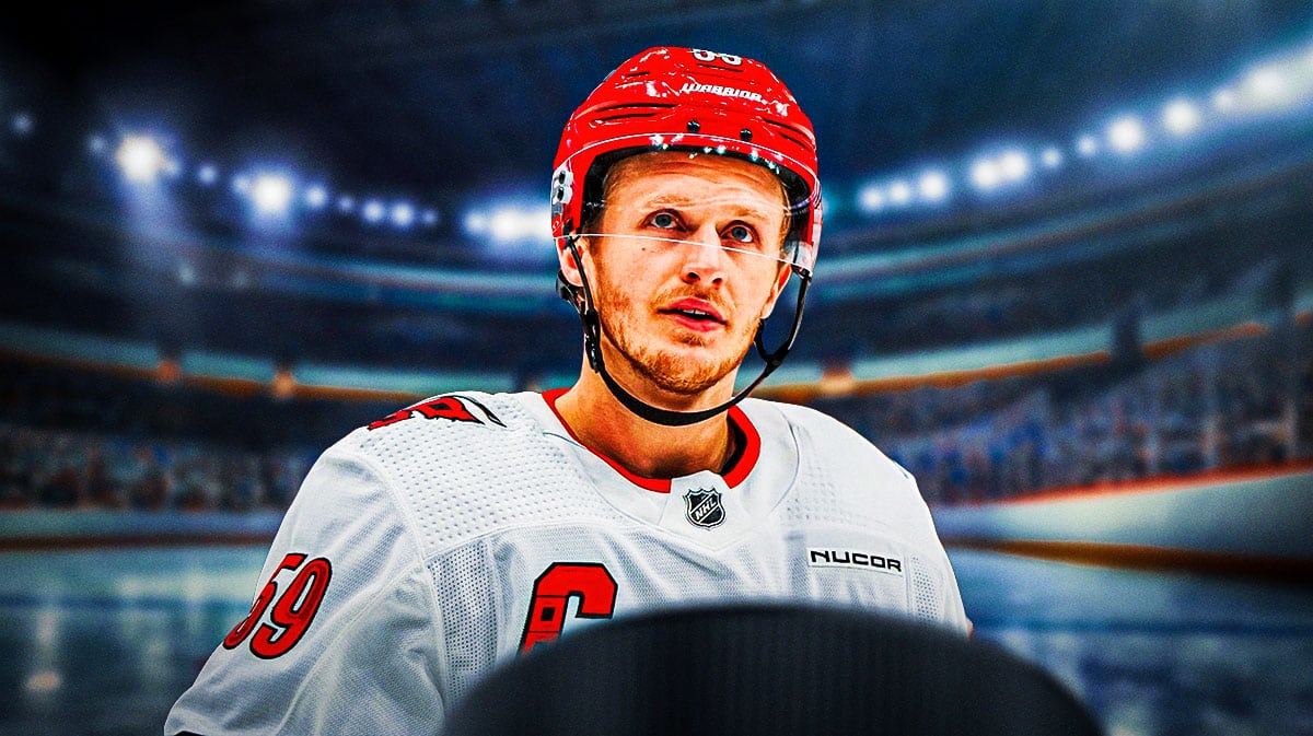 Jake Guentzel in image looking stern, hockey rink in background