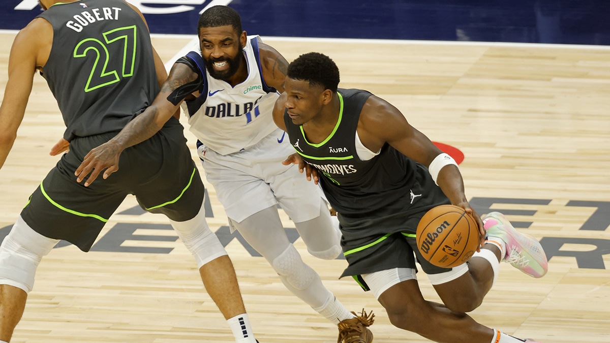 Minnesota Timberwolves guard Anthony Edwards (5) dribbles against Dallas Mavericks guard Kyrie Irving (11) during the second half in game five of the western conference finals for the 2024 NBA playoffs at Target Center