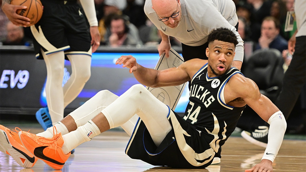 Milwaukee Bucks forward Giannis Antetokounmpo (34) is helped off the floor in the third quarter and left game against the Boston Celtics with an injury at Fiserv Forum