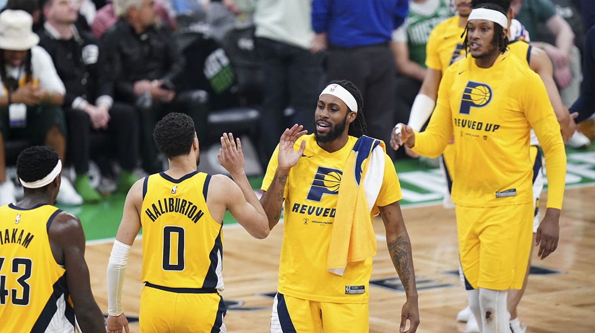 Indiana Pacers guard Tyrese Haliburton (0) and teammates react after his three point basket against the Boston Celtics in the third quarter during game one of the eastern conference finals for the 2024 NBA playoffs at TD Garden