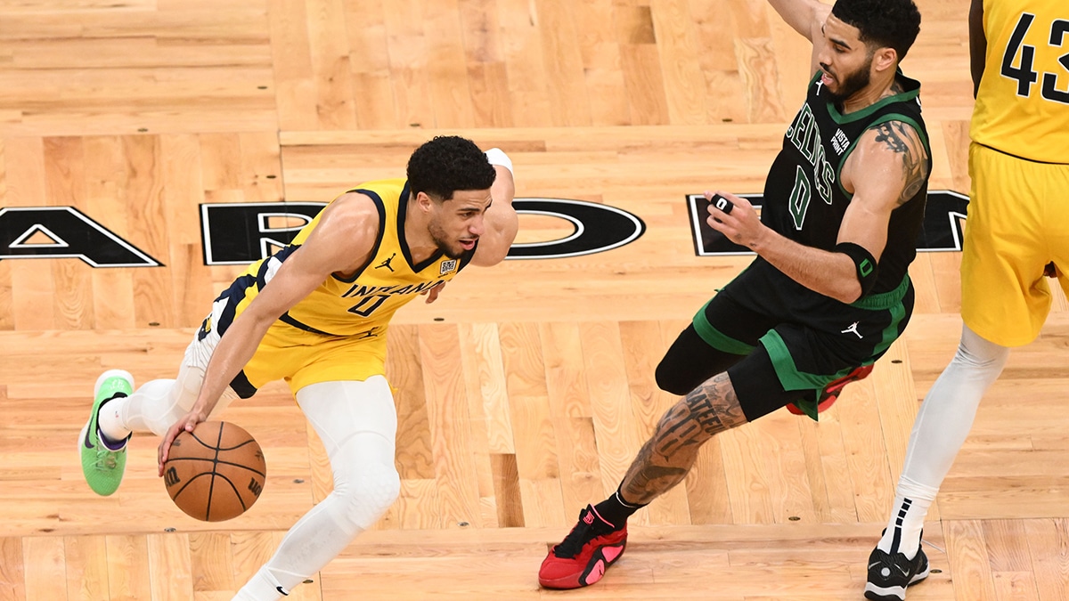 May 23, 2024; Boston, Massachusetts, USA; Indiana Pacers guard Tyrese Haliburton (0) dribbles the ball against Boston Celtics forward Jayson Tatum (0) in the first half during game two of the eastern conference finals for the 2024 NBA playoffs at TD Garden. Mandatory Credit: Brian Fluharty-USA TODAY Sports
