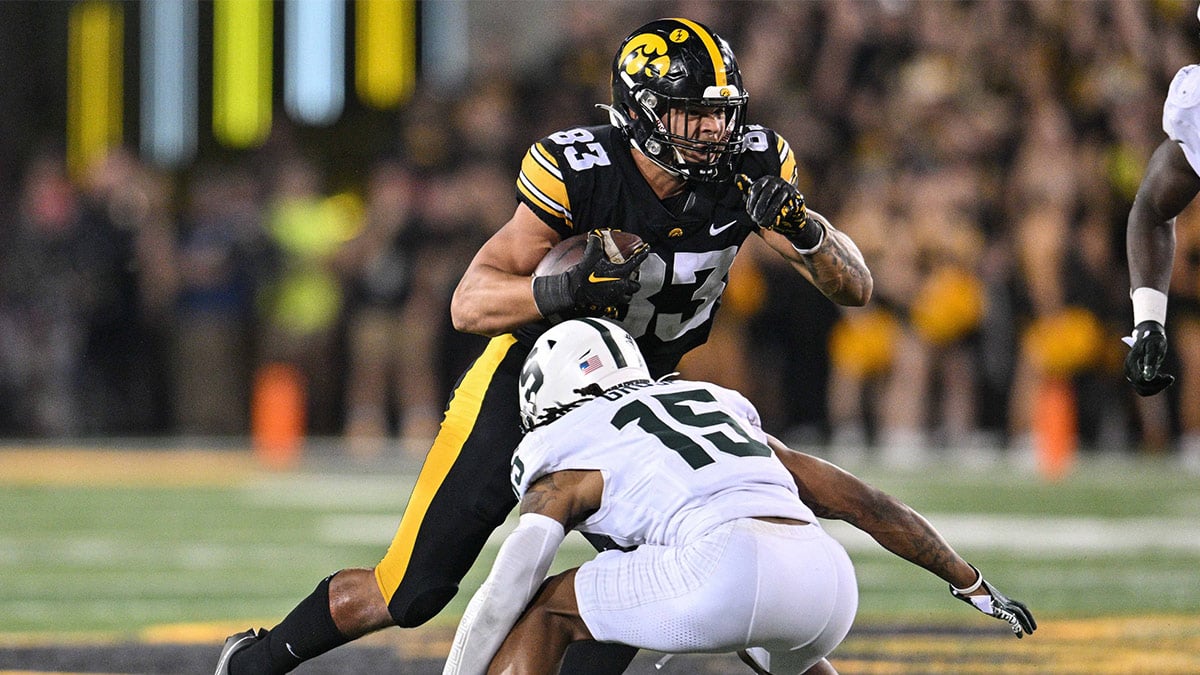 Iowa Hawkeyes tight end Erick All (83) is tackled by Michigan State Spartans defensive back Angelo Grose (15) during the fourth quarter at Kinnick Stadium.