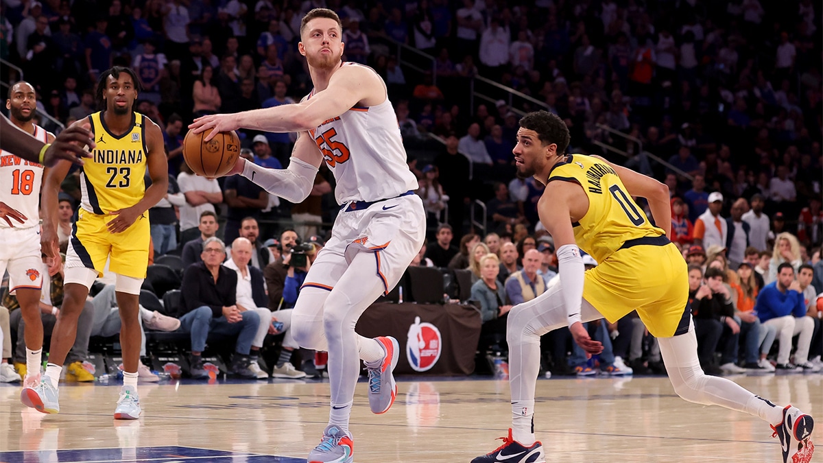 New York Knicks center Isaiah Hartenstein (55) looks to pass the ball against Indiana Pacers forward Aaron Nesmith (23) and guard Tyrese Haliburton (0) during the fourth quarter of game seven of the second round of the 2024 NBA playoffs at Madison Square Garden.