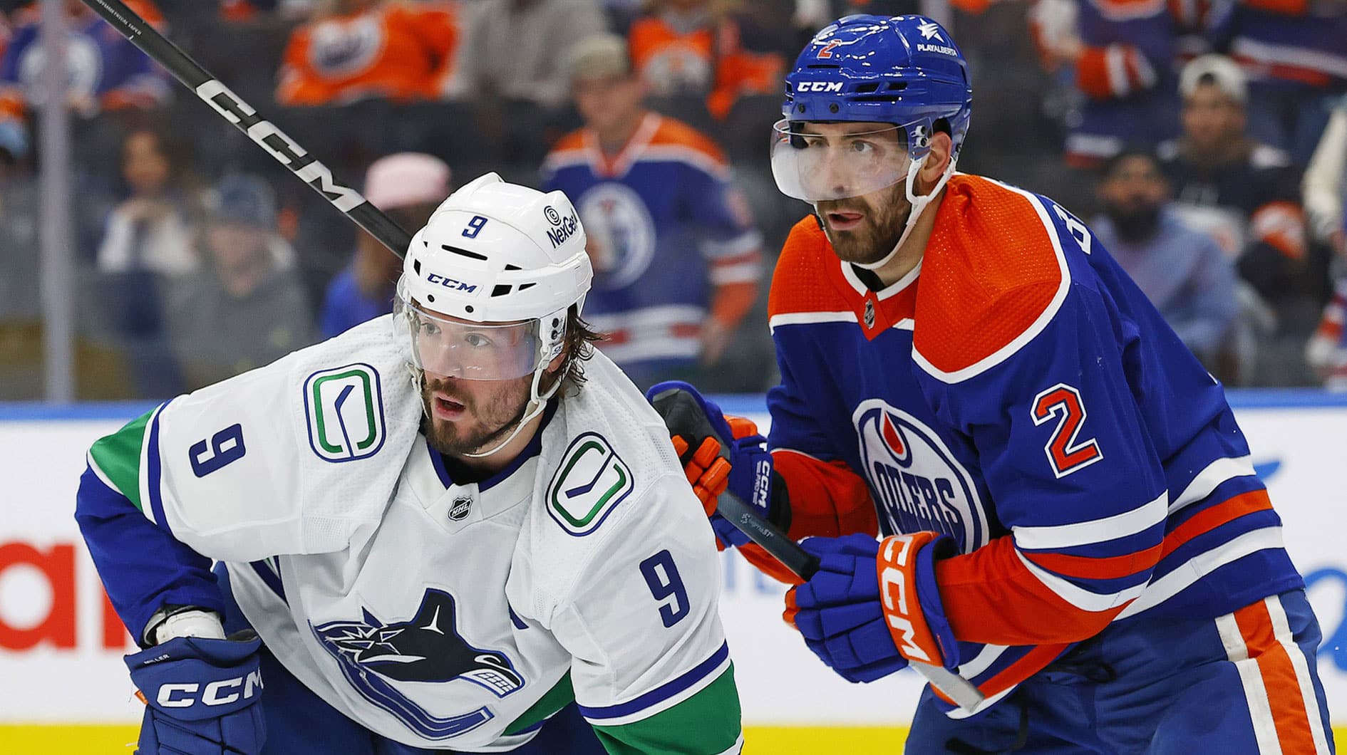 Vancouver Canucks forward J.T. Miller (9) and Edmonton Oilers defensemen Evan Bouchard (2) battle for position during the second period in game six of the second round of the 2024 Stanley Cup Playoffs at Rogers Place.