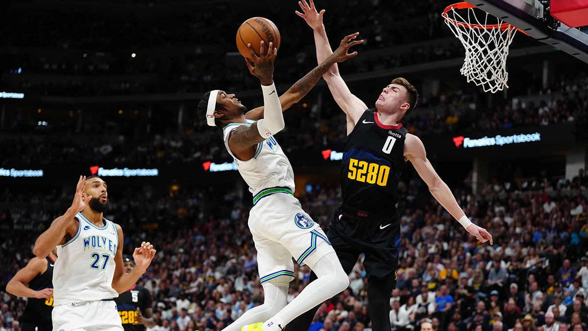 Minnesota Timberwolves forward Jaden McDaniels (3) shoots at Denver Nuggets guard Christian Braun (0) in the first half in game seven of the second round for the 2024 NBA playoffs at Ball Arena