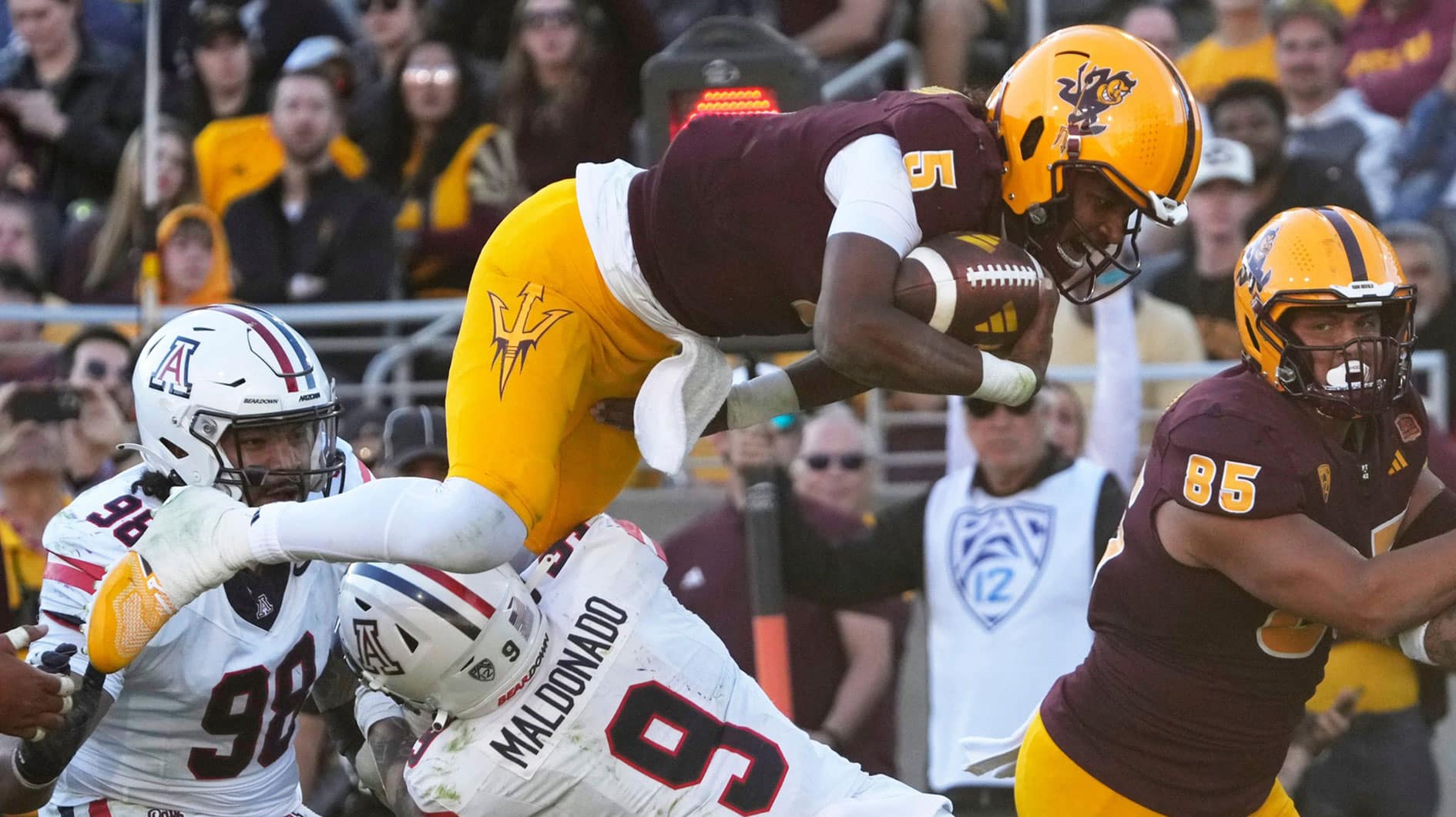 Arizona State quarterback Jaden Rashada is tackled by Arizona safety Gunner Maldonado (9) during the third quarter at Mountain America Stadium