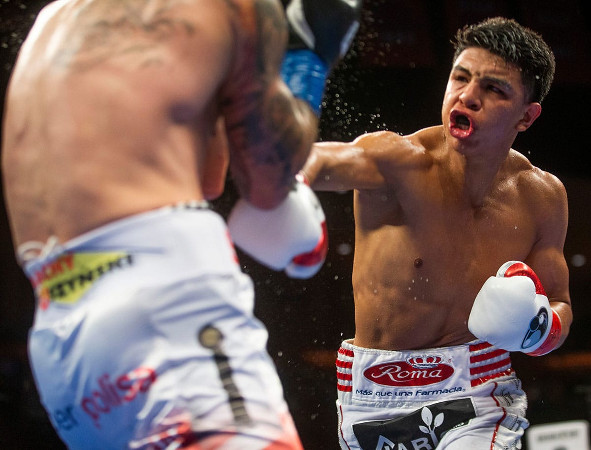 Jaime Munguia throwing a punch in a boxing match