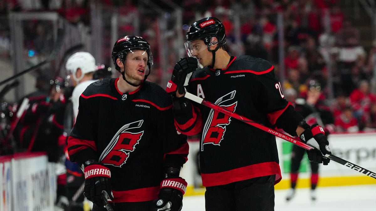 Carolina Hurricanes center Sebastian Aho (20) and Carolina Hurricanes center Jake Guentzel (59) talk against the New York Islanders during the first period in game one of the first round of the 2024 Stanley Cup Playoffs at PNC Arena.