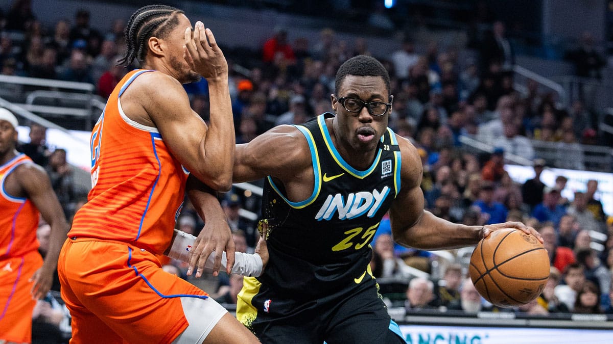 Indiana Pacers forward Jalen Smith (25) dribbles the ball while Oklahoma City Thunder guard Aaron Wiggins (21) defends in the first half at Gainbridge Fieldhouse.