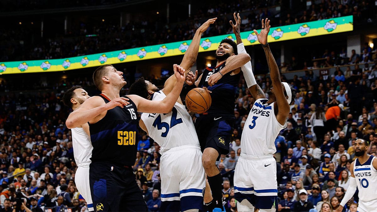  Denver Nuggets guard Jamal Murray (27) loses control of the ball against Minnesota Timberwolves center Karl-Anthony Towns (32) and forward Jaden McDaniels (3) as center Nikola Jokic (15) defends in the third quarter during game two of the second round for the 2024 NBA playoffs at Ball Arena
