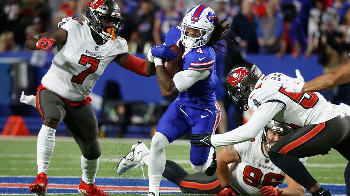 Buffalo Bills running back James Cook (4) finds a hole at the line of scrimmage.