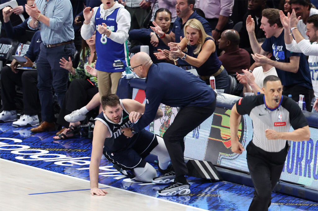 Dallas Mavericks head coach Jason Kidd helping Luka Doncic to his feet