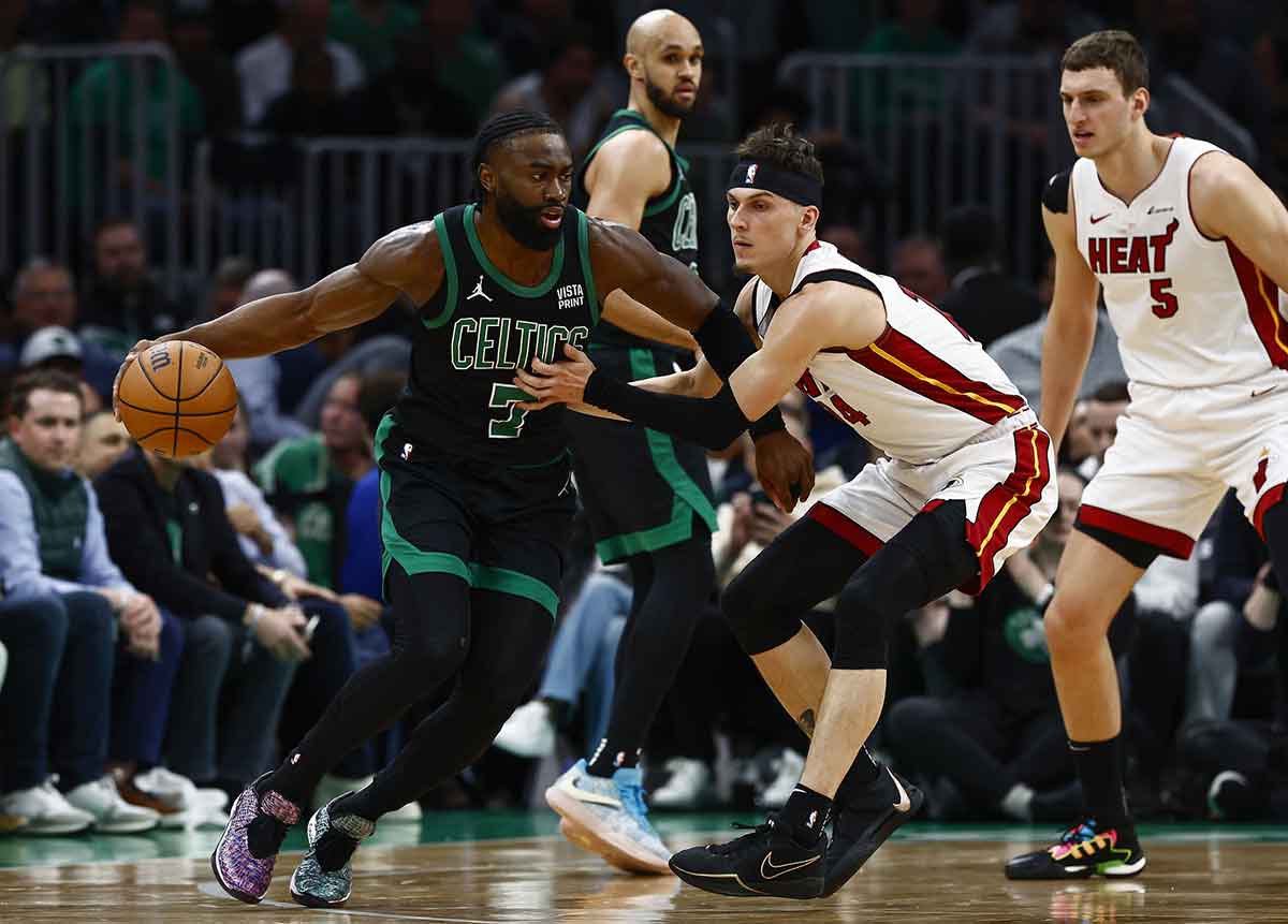 May 1, 2024; Boston, Massachusetts, USA; Boston Celtics guard Jaylen Brown (7) looks to get around Miami Heat guard Tyler Herro (14) during the first quarter of game five of the first round of the 2024 NBA playoffs at TD Garden. Mandatory Credit: Winslow Townson-USA TODAY Sports