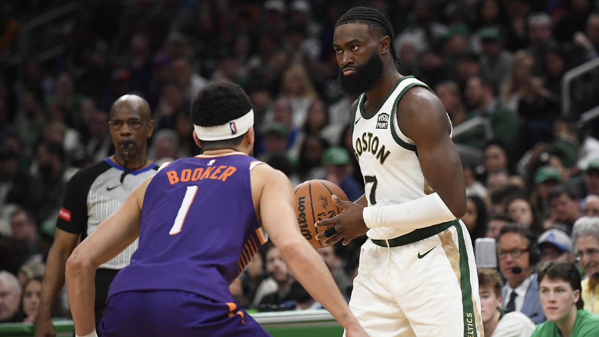 Boston Celtics guard Jaylen Brown (7) controls the ball while Phoenix Suns guard Devin Booker (1) defends during the second half at TD Garden. 