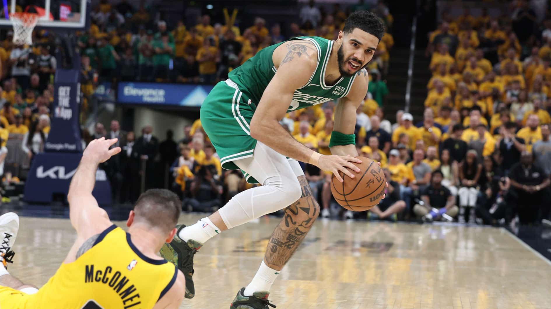 Boston Celtics forward Jayson Tatum (0) controls the ball against Indiana Pacers guard T.J. McConnell (9) during the fourth quarter of game three of the eastern conference finals in the 2024 NBA playoffs at Gainbridge Fieldhouse.